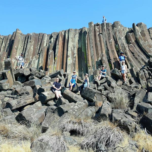 Group photo of students in front of amazing columnar basalt on GEOL390 field trip to Yellowstone